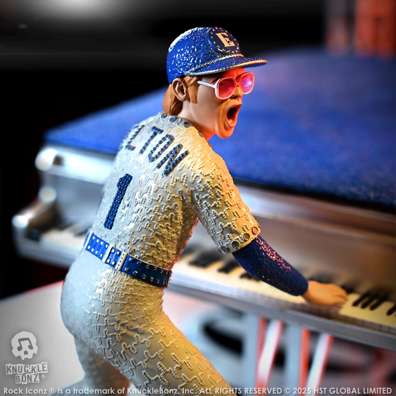 Statue of Elton John with a grand piano in a baseball uniform with 'Elton' on the back