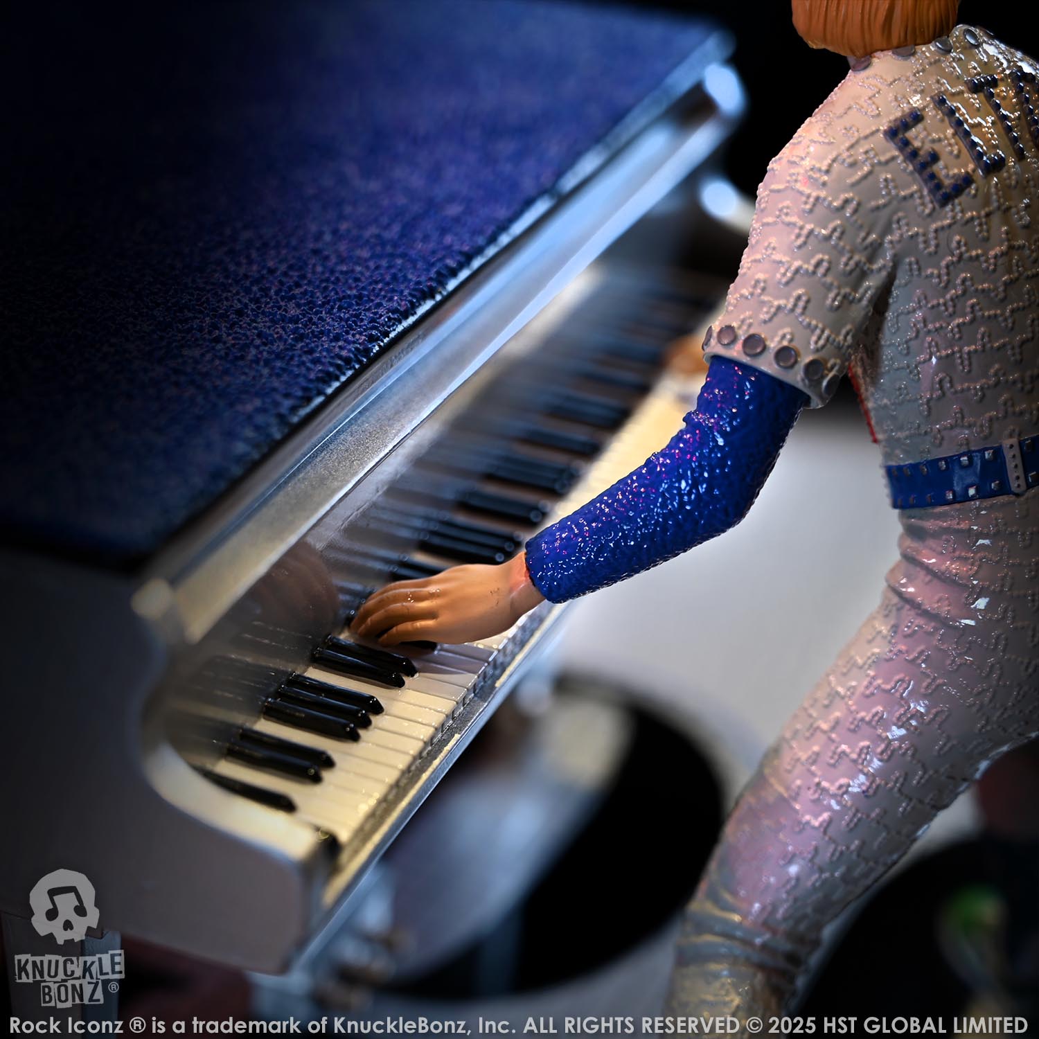 Statue of Elton John with a grand piano in a baseball uniform with a dark background