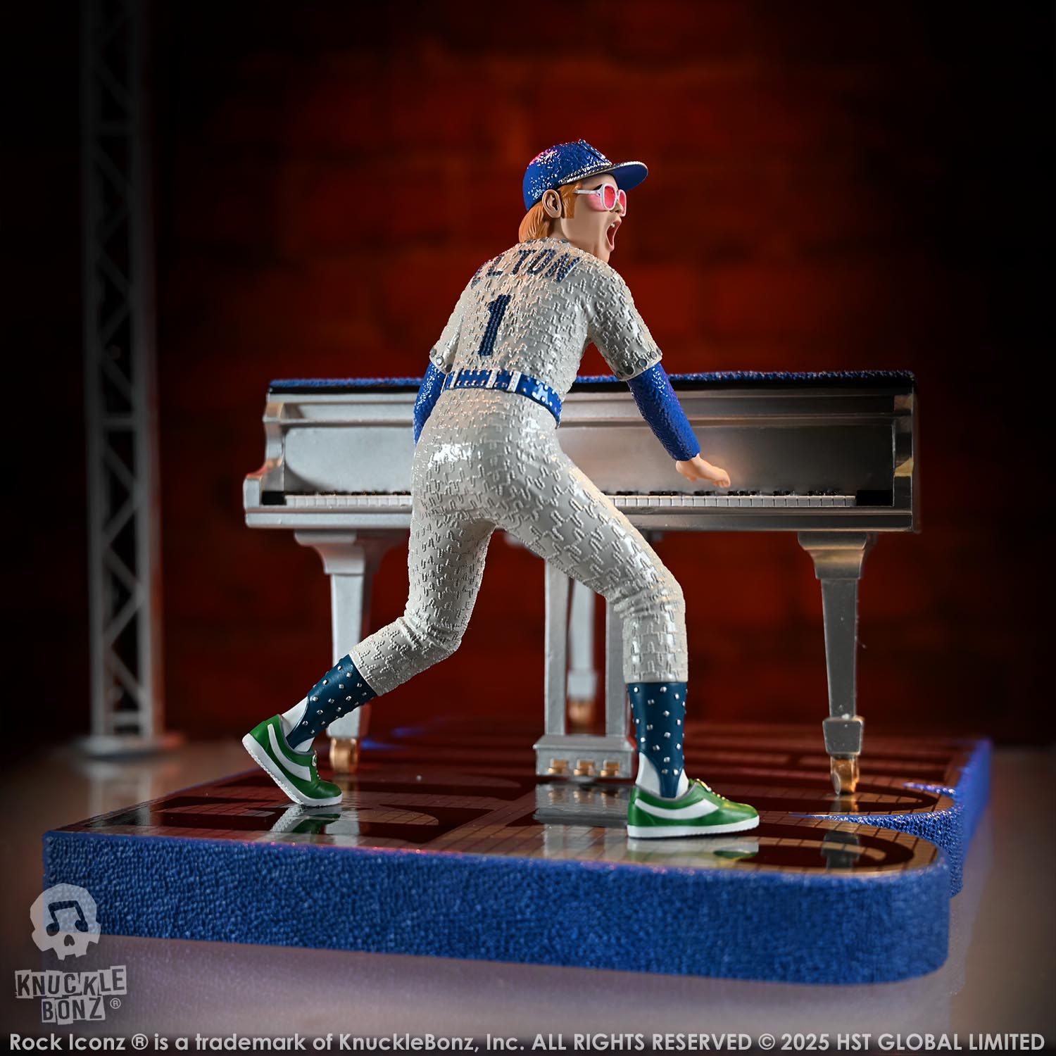 Statue of Elton John with a grand piano in a baseball uniform with a red background