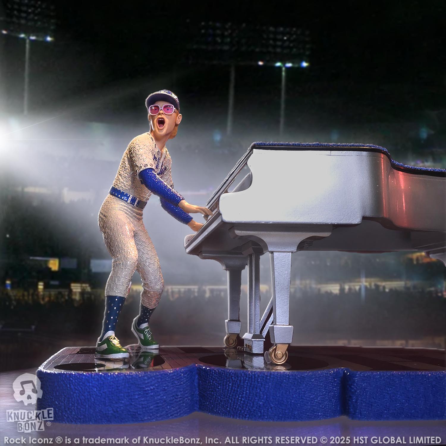 Statue of Elton John with a grand piano in a baseball uniform with a stadium background