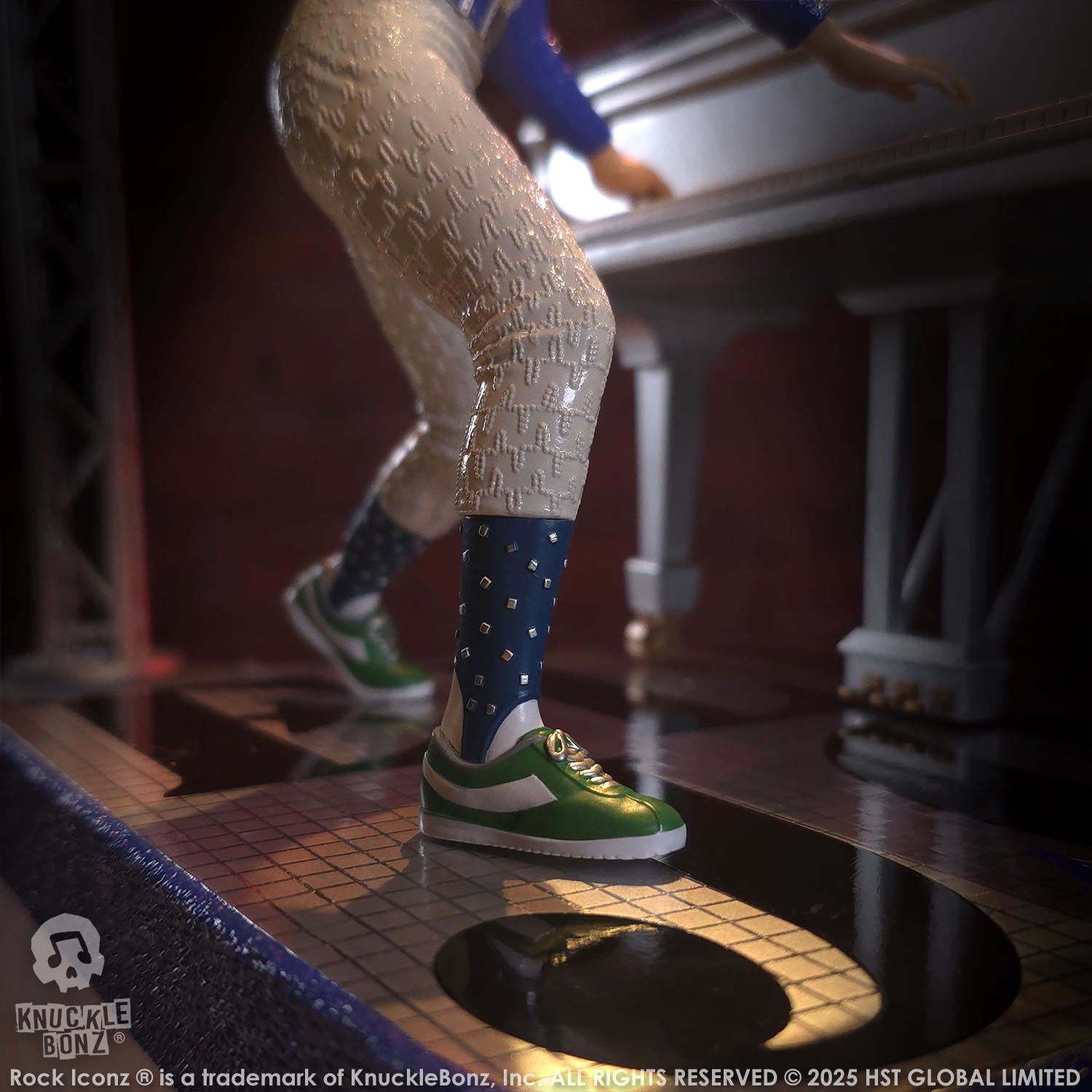 Statue of Elton John with a grand piano in a baseball uniform with a red background