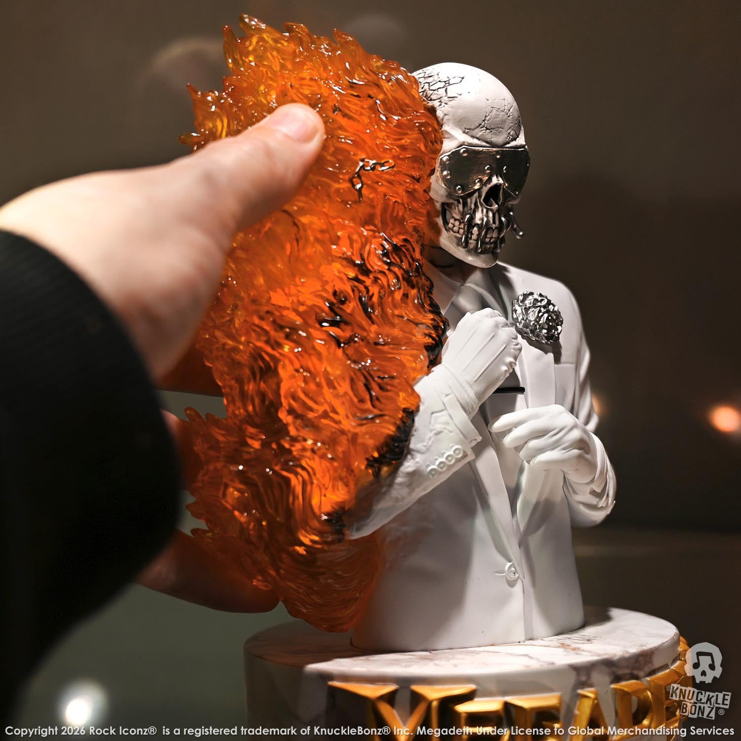 Limited edition statue of a skeleton in a white suit with red and orange flames. The statue s part of the 3D Vinyl KnuckleBonz collection.