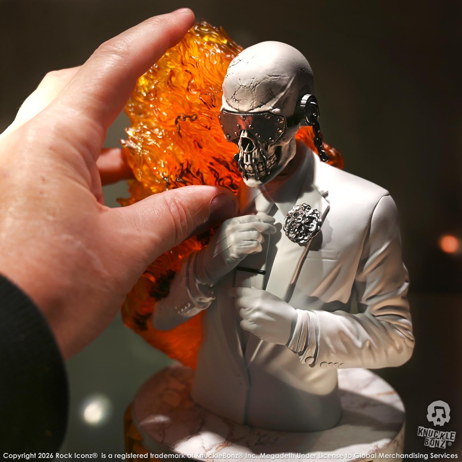 Limited edition statue of a skeleton in a white suit with red and orange flames. The statue s part of the 3D Vinyl KnuckleBonz collection.