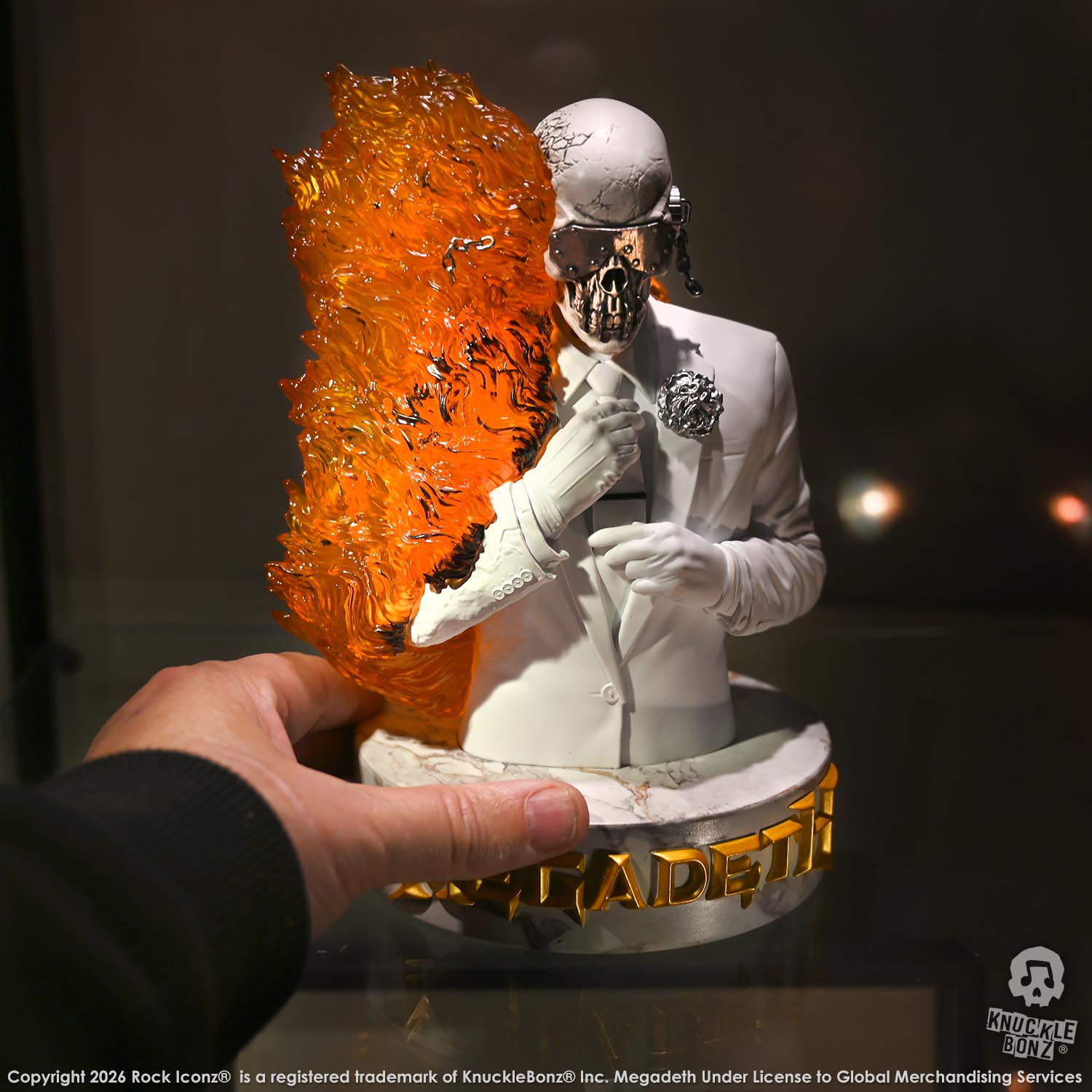 Limited edition statue of a skeleton in a white suit with red and orange flames. The statue s part of the 3D Vinyl KnuckleBonz collection.