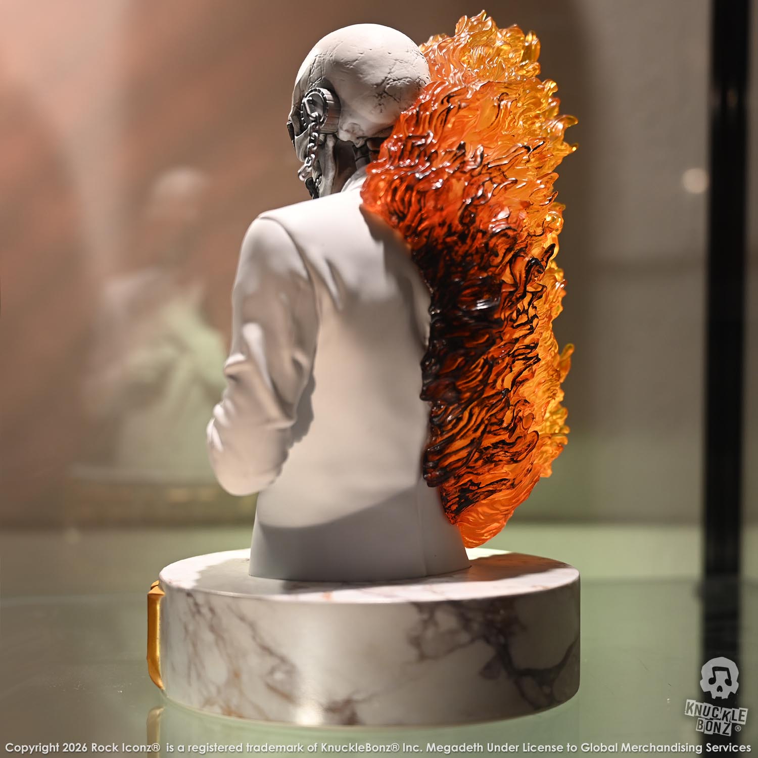 Limited edition statue of a skeleton in a white suit with red and orange flames. The statue s part of the 3D Vinyl KnuckleBonz collection.