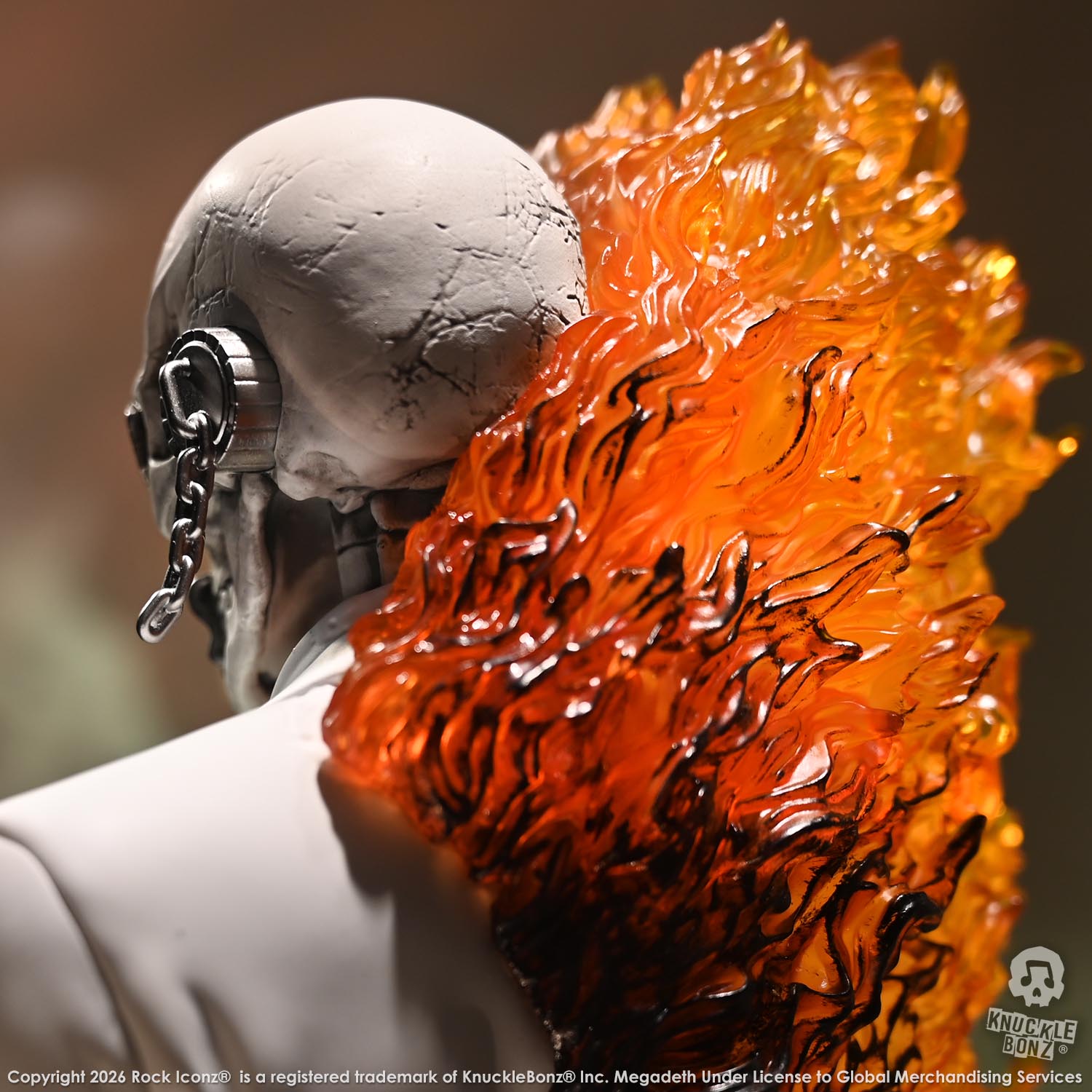 Limited edition statue of a skeleton in a white suit with red and orange flames. The statue s part of the 3D Vinyl KnuckleBonz collection.