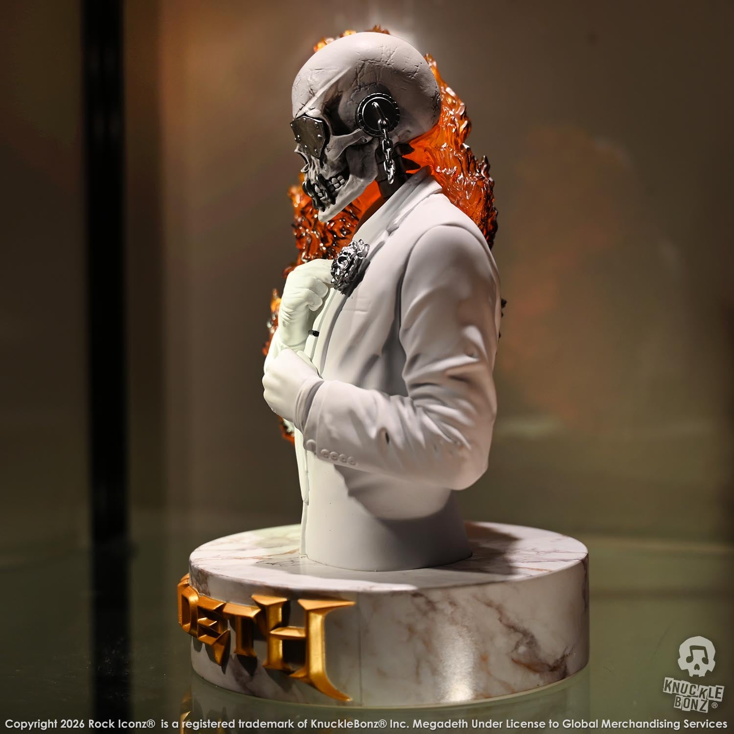 Limited edition statue of a skeleton in a white suit with red and orange flames. The statue s part of the 3D Vinyl KnuckleBonz collection.