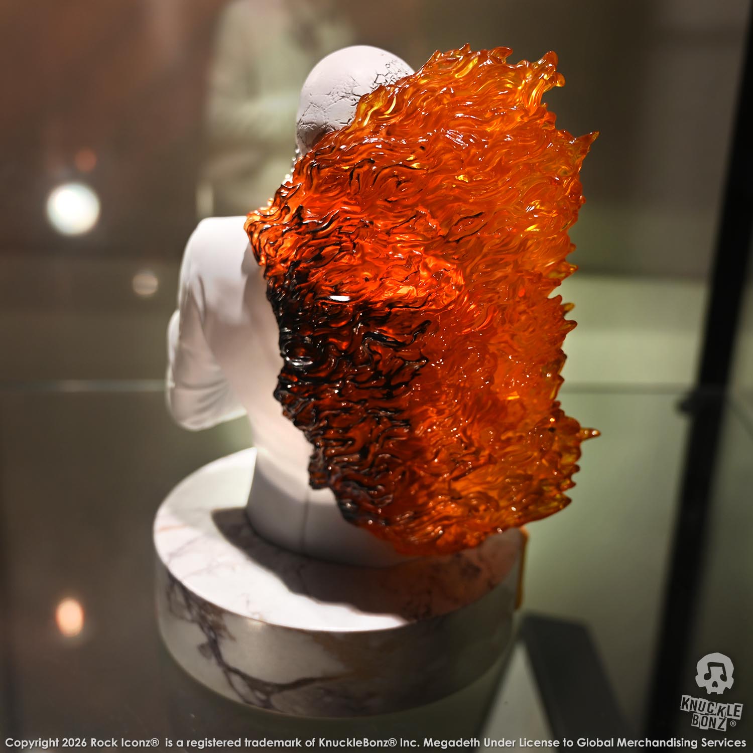 Limited edition statue of a skeleton in a white suit with red and orange flames. The statue s part of the 3D Vinyl KnuckleBonz collection.