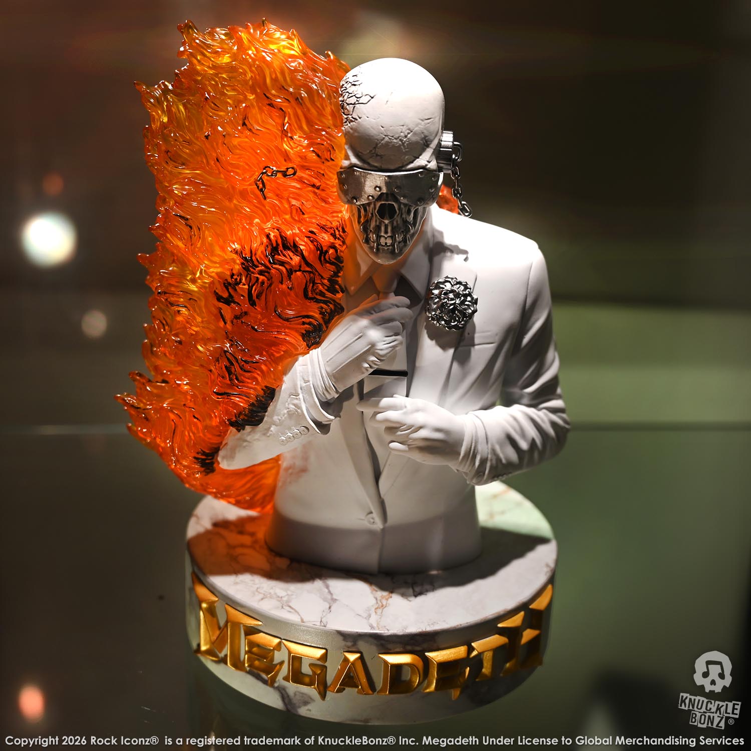 Limited edition statue of a skeleton in a white suit with red and orange flames. The statue s part of the 3D Vinyl KnuckleBonz collection.