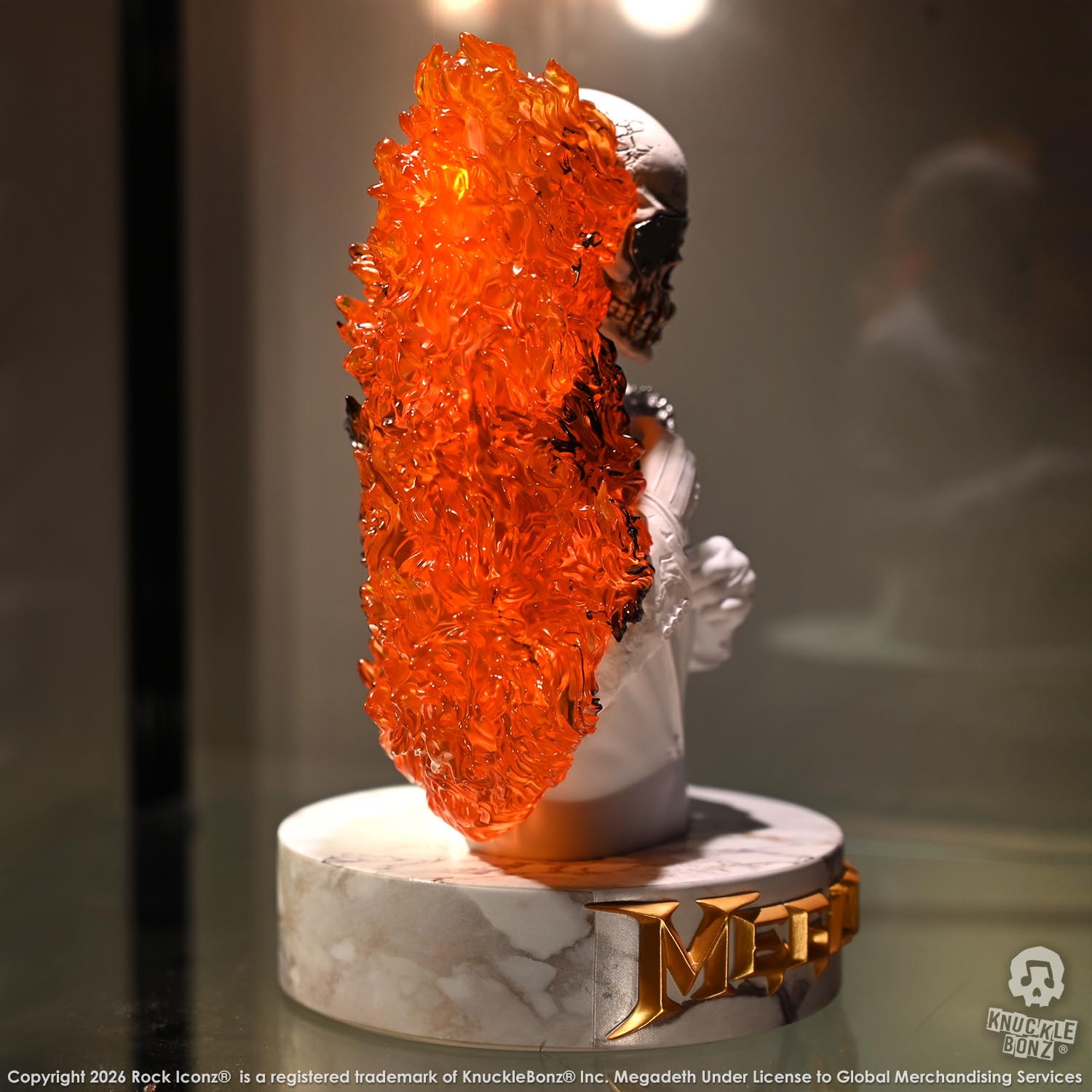 Limited edition statue of a skeleton in a white suit with red and orange flames. The statue s part of the 3D Vinyl KnuckleBonz collection.