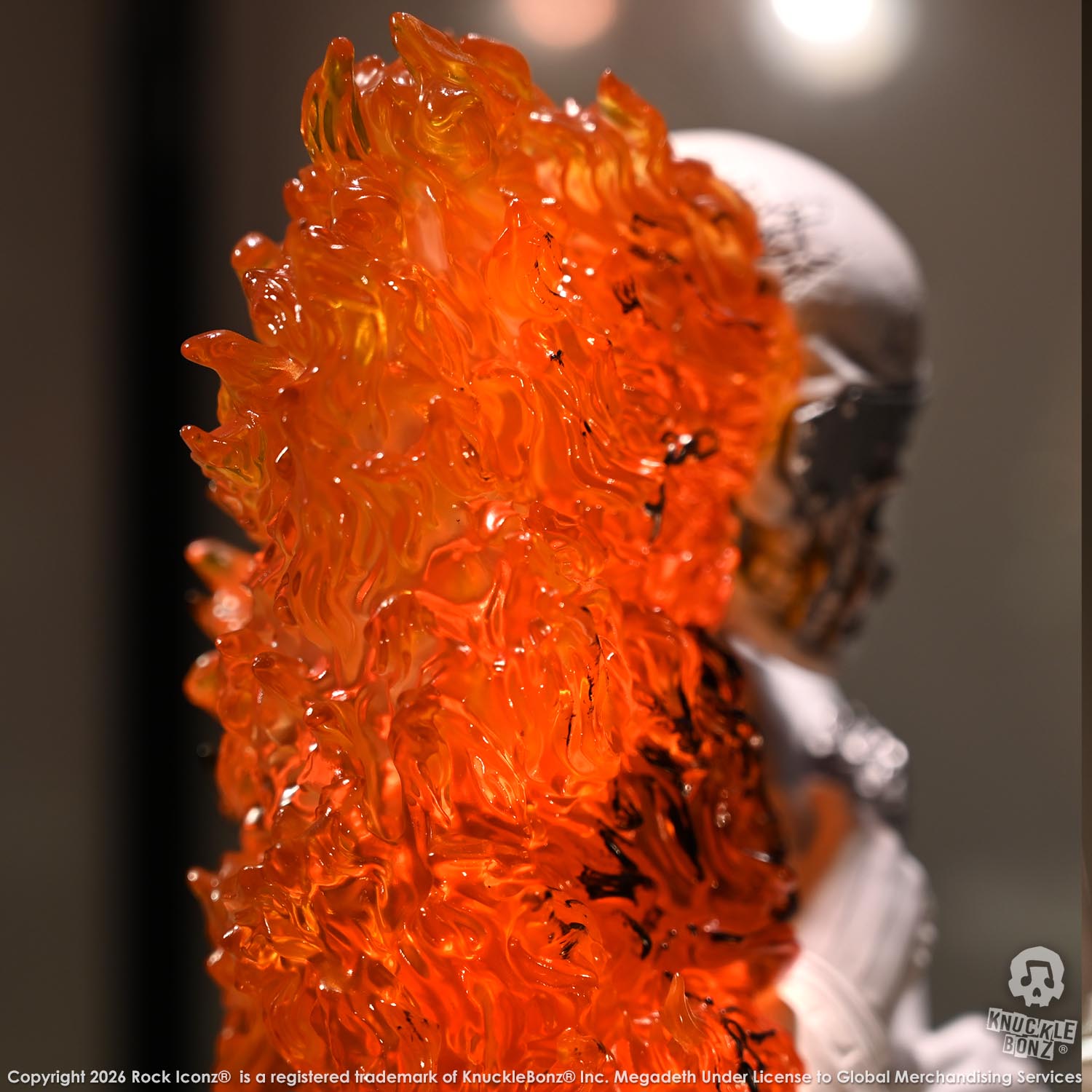Limited edition statue of a skeleton in a white suit with red and orange flames. The statue s part of the 3D Vinyl KnuckleBonz collection.