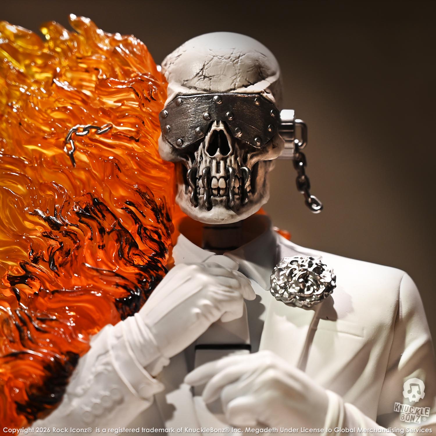 Limited edition statue of a skeleton in a white suit with red and orange flames. The statue s part of the 3D Vinyl KnuckleBonz collection.