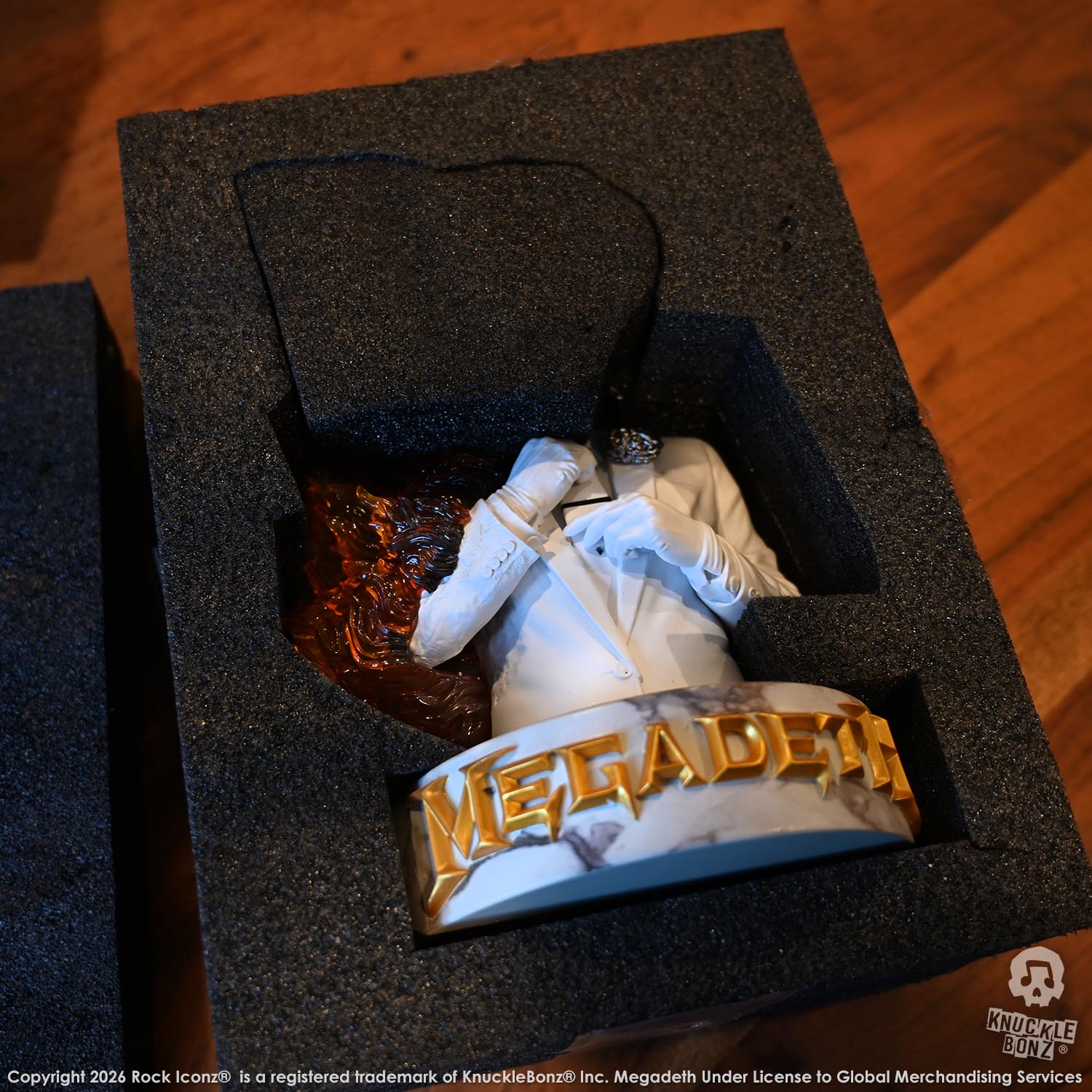 Limited edition statue of a skeleton in a white suit with red and orange flames. The statue s part of the 3D Vinyl KnuckleBonz collection.