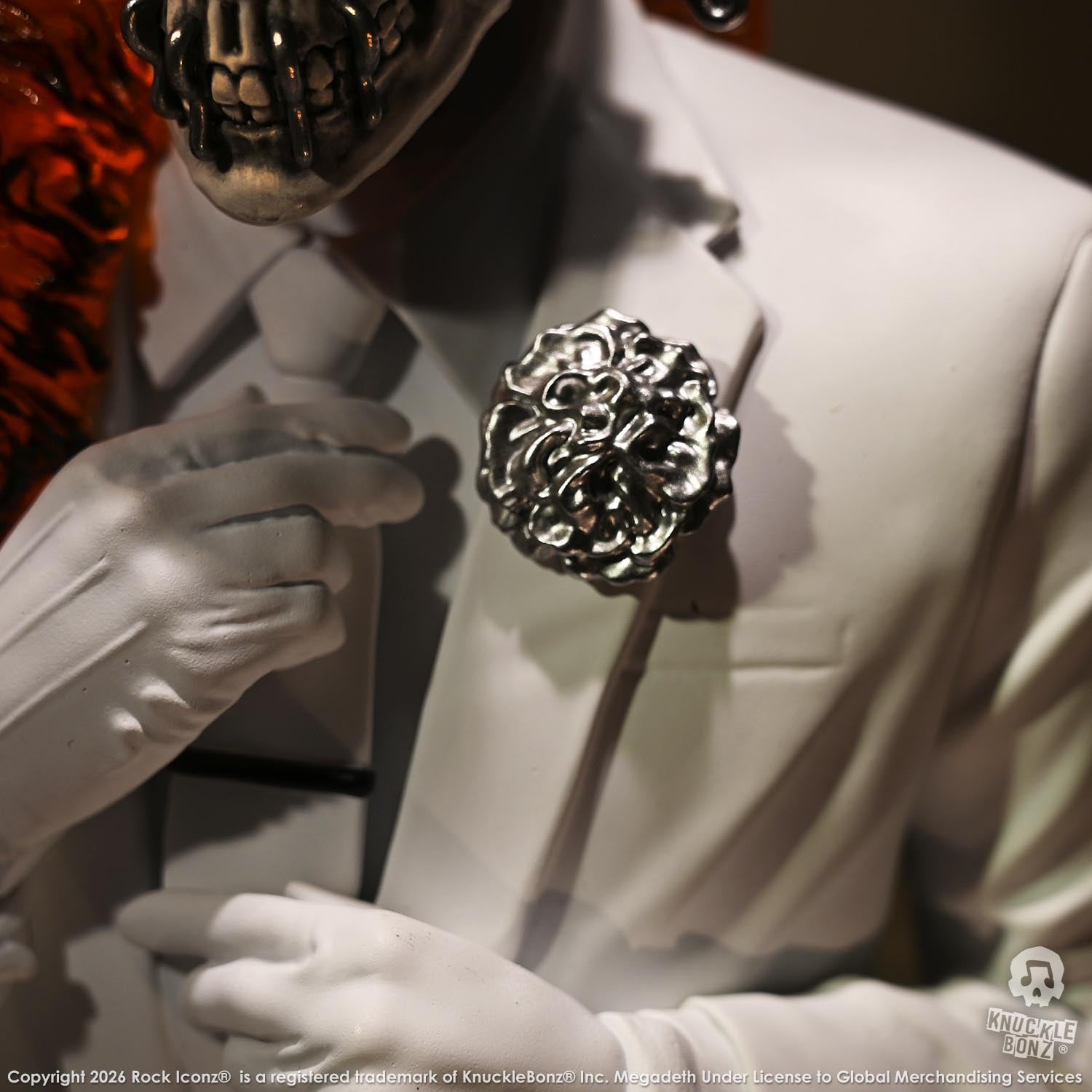 Limited edition statue of a skeleton in a white suit with red and orange flames. The statue s part of the 3D Vinyl KnuckleBonz collection.