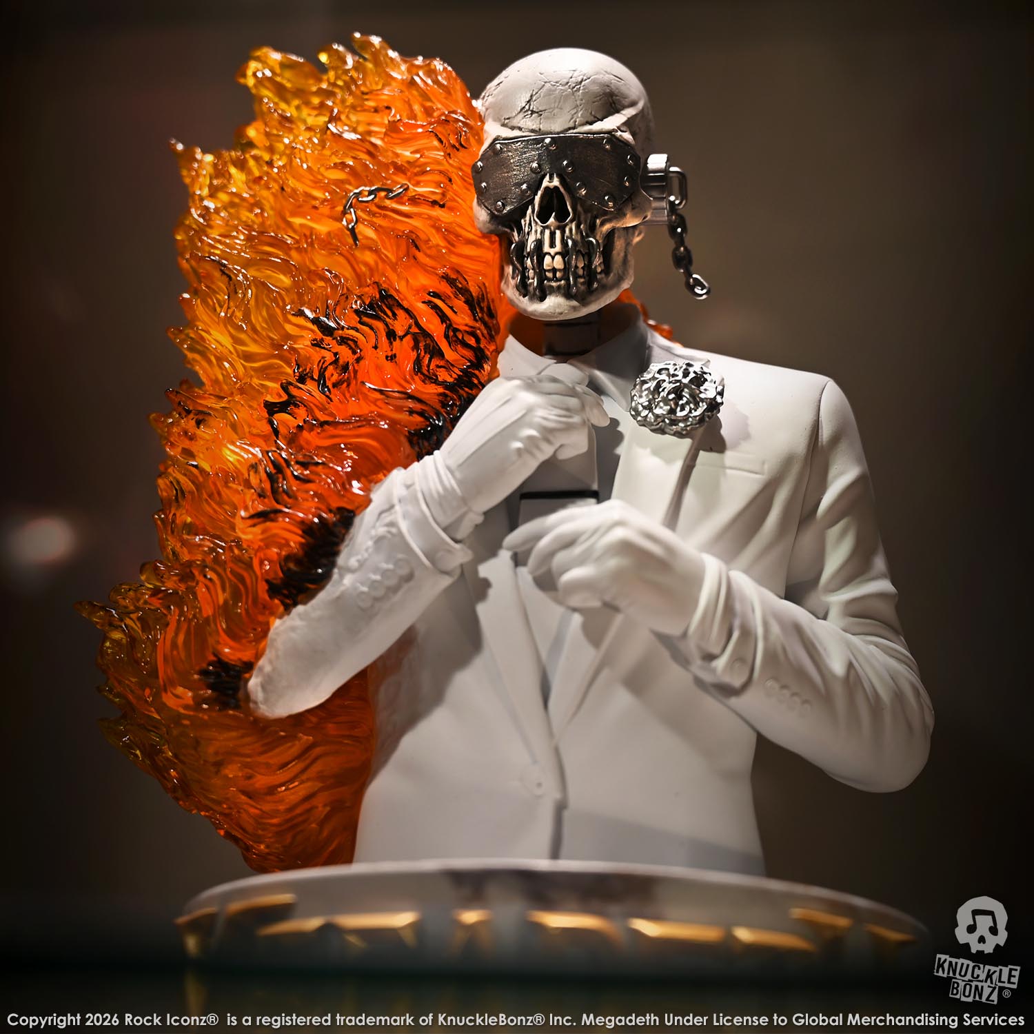 Limited edition statue of a skeleton in a white suit with red and orange flames. The statue s part of the 3D Vinyl KnuckleBonz collection.