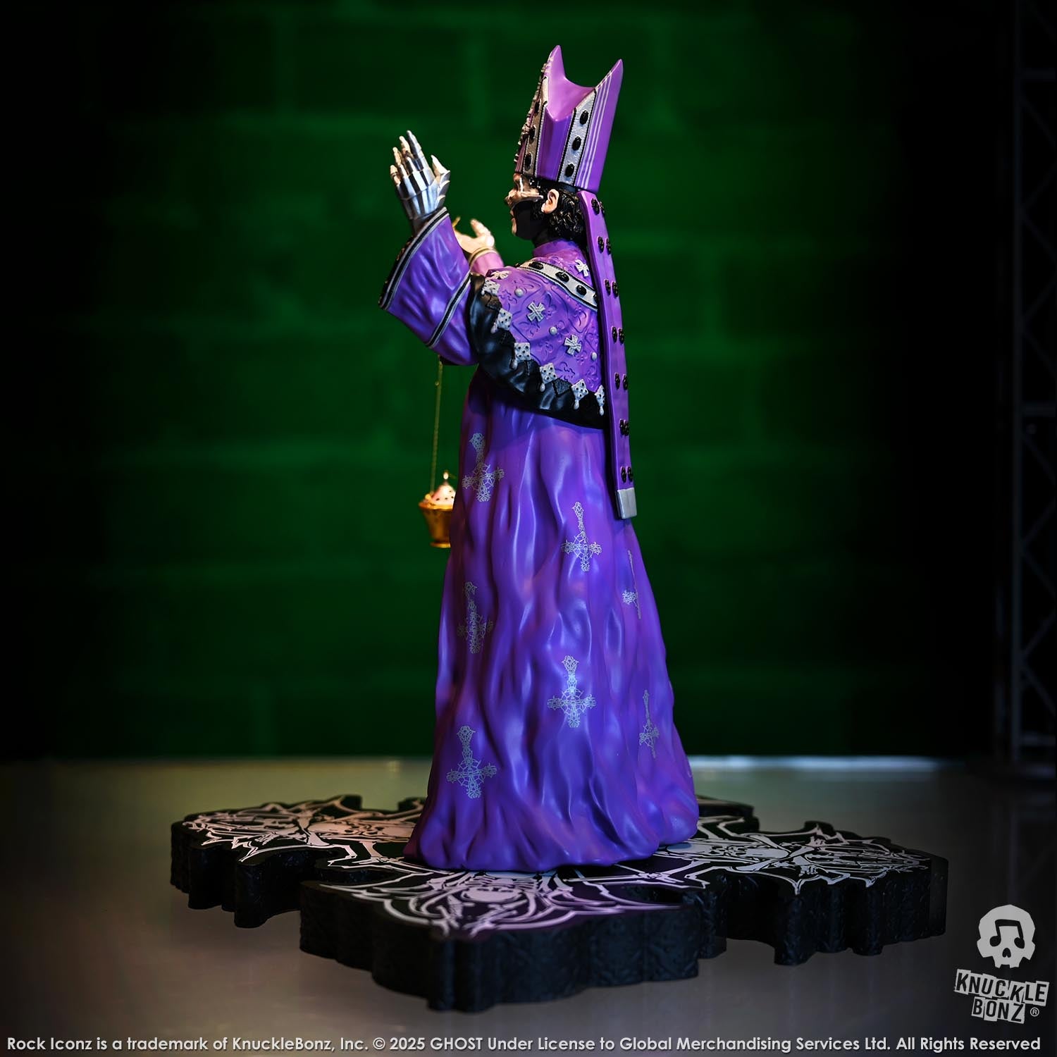Statue of Papa V Perpetua from Ghost  in a purple robe with a green background