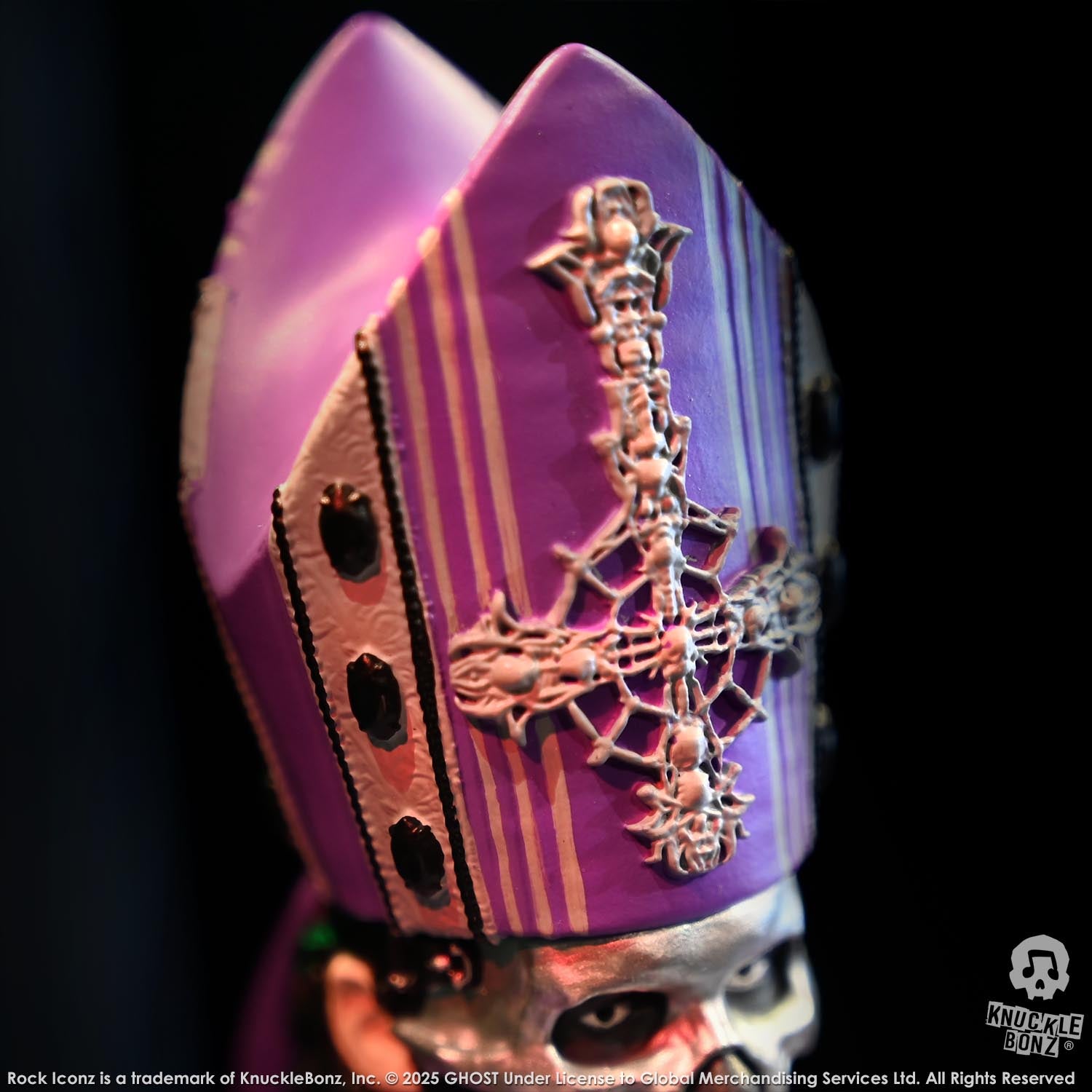 Purple and white mask with intricate design on a black background