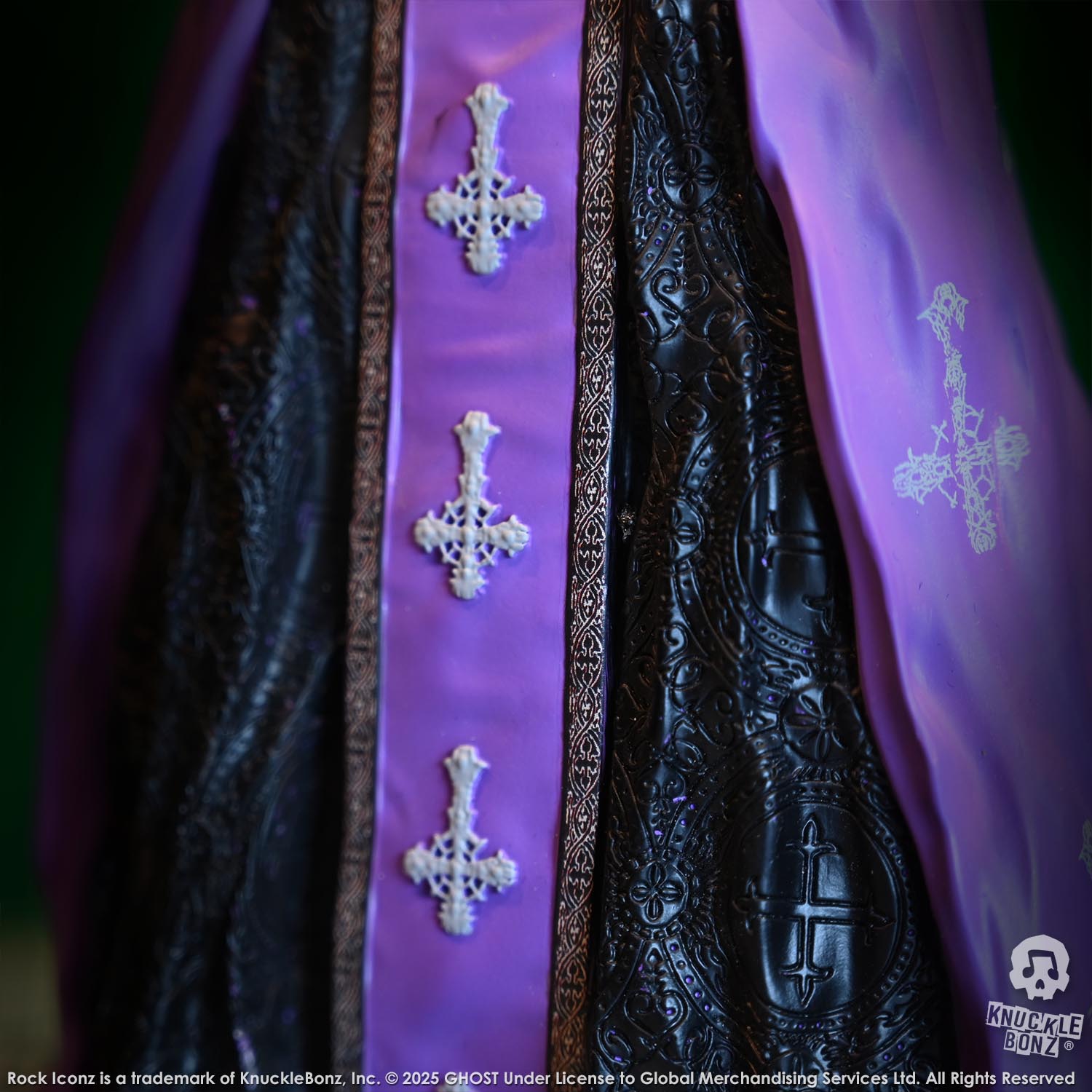 Decorative purple sash with cross patterns on a dark background