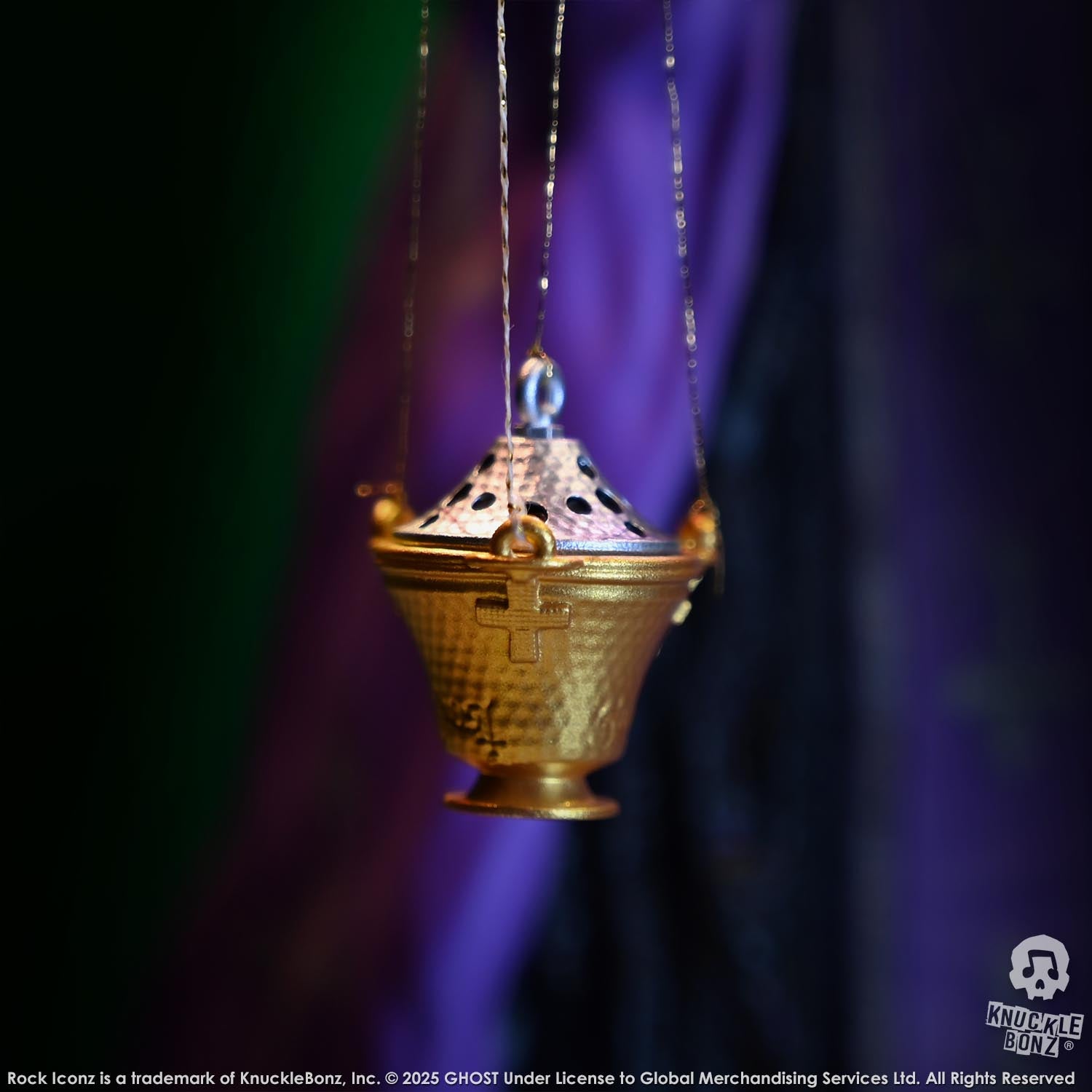 Decorative hanging lantern with intricate design against a dark background