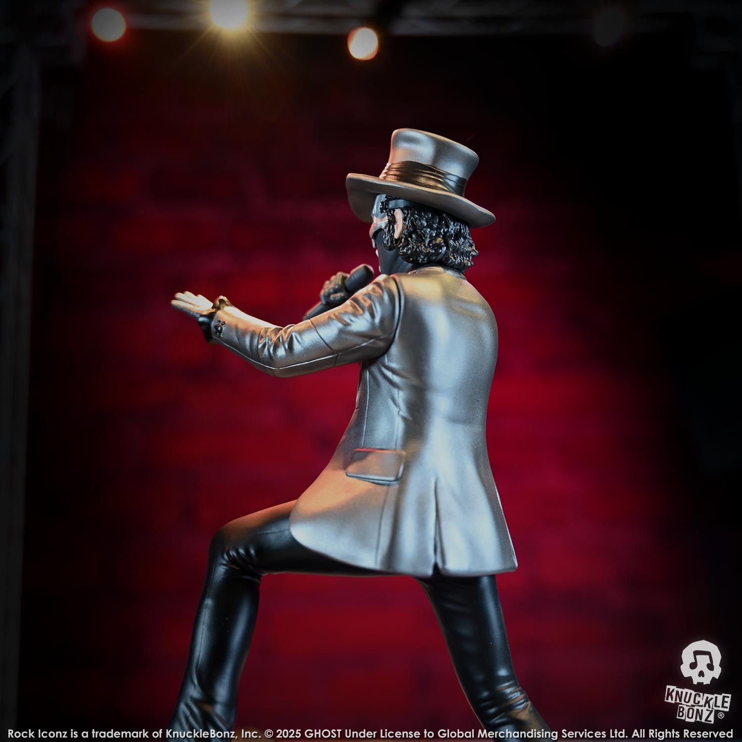 Statue of Papa V Perpetua from Ghost in a silver suit coat and top hat with a red background
