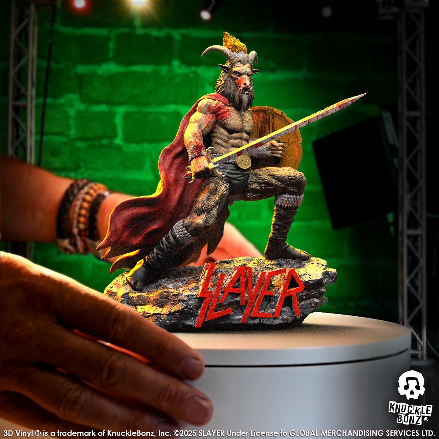 Statue of the Slayer Show No Mercy statue with a sword and shield, featuring the Slayer logo with a green background